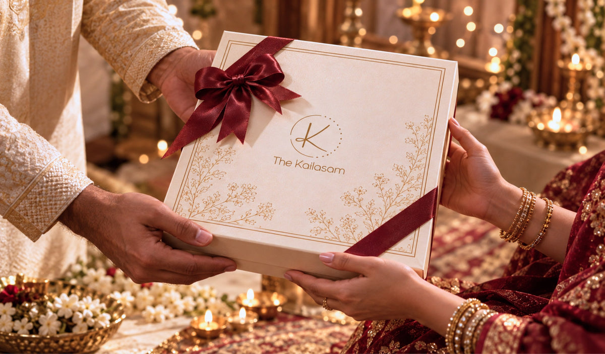 Hands passing a Kailasam gift box